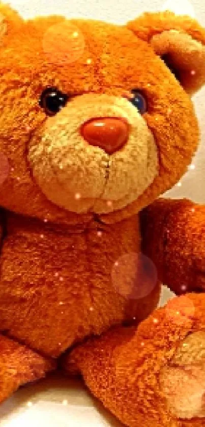 Orange plush teddy bear with a white background.