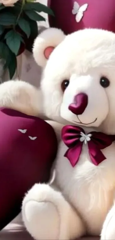 Fluffy teddy bear with burgundy bow and heart pillows.