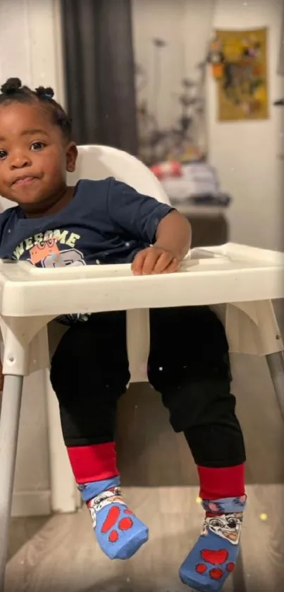 Adorable toddler sitting in a highchair, wearing colorful socks.