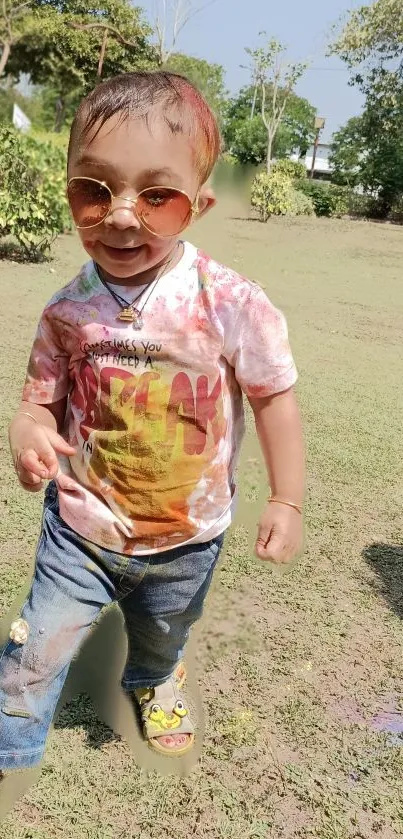 Adorable toddler in sunglasses enjoying a sunny day in the park.