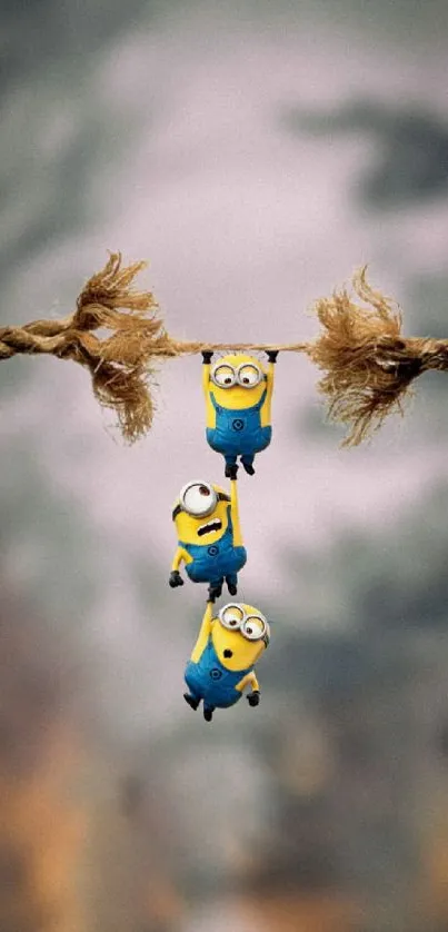 Minions trio humorously hanging from rope, playful background.