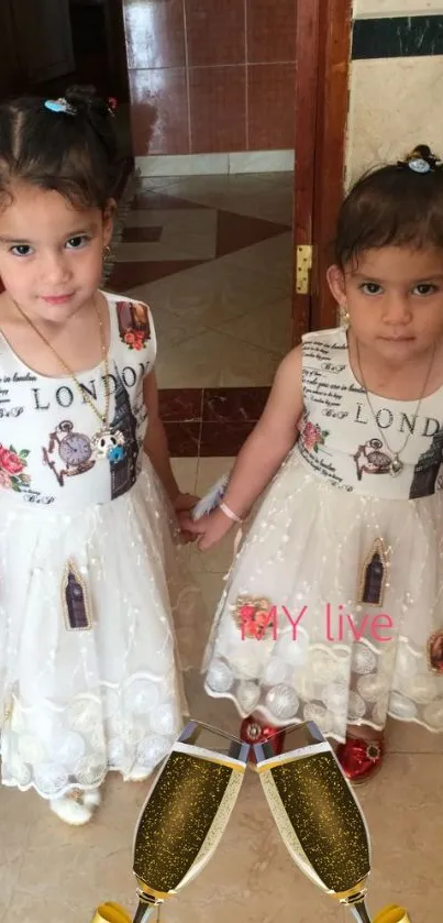 Twin girls in white dresses with champagne glasses overlay.