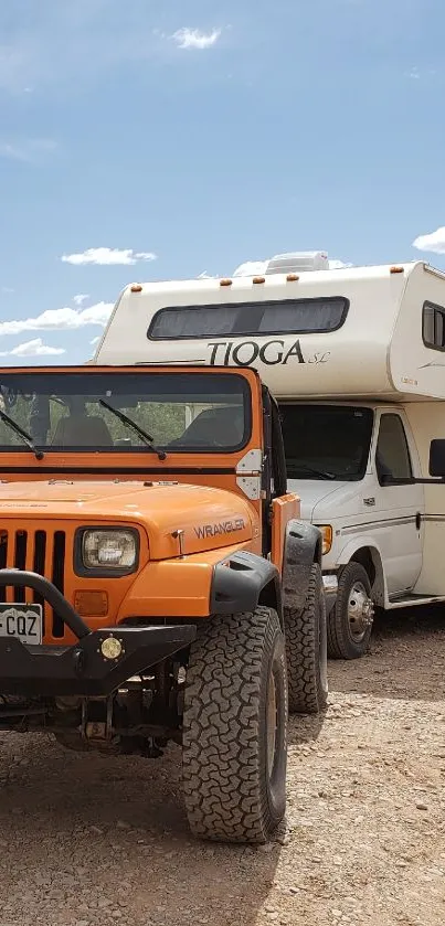 Orange Jeep and camper in desert setting.