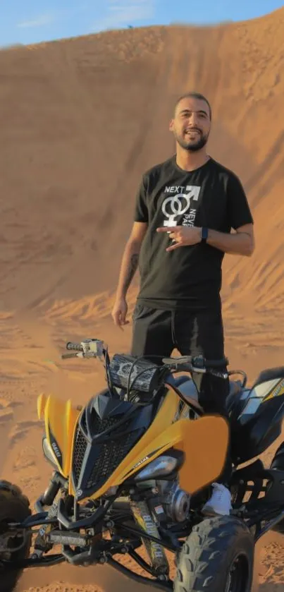 Person riding yellow ATV on sandy dunes.