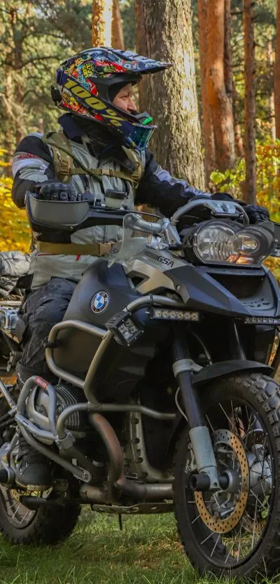 Motorcyclist riding through autumn forest with vibrant yellow leaves.