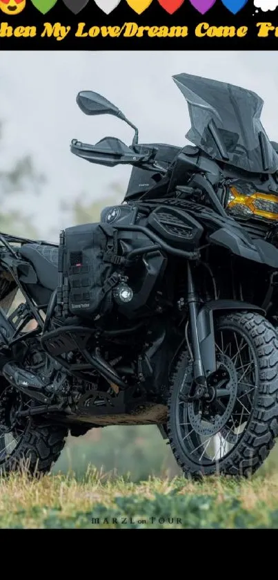 A black adventure motorcycle parked on grass in a scenic landscape.