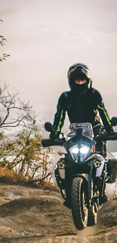 Motorcycle rider on a rugged trail during sunset.