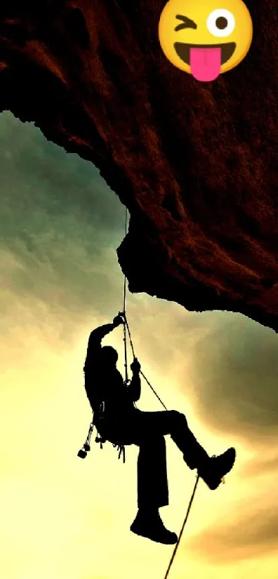 Silhouetted rock climber at dusk with a fun emoji, set against an amber sky.