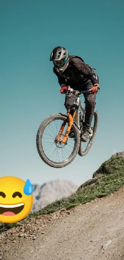 Mountain biker jumping on trail with cyan sky.
