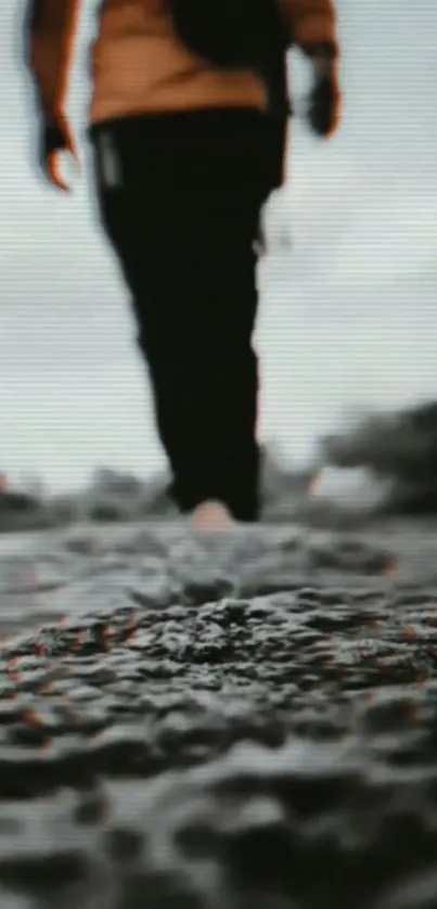 Blurred image of person walking on a rugged path.