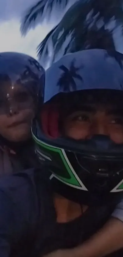 Two friends riding a motorcycle with helmets under palm trees at dusk.