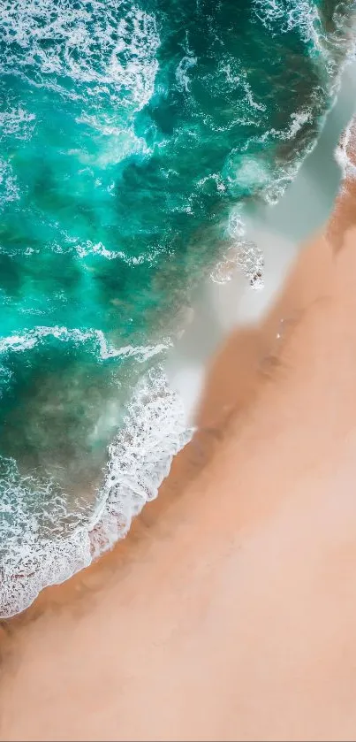 Aerial view of turquoise ocean waves meeting a sandy beach.