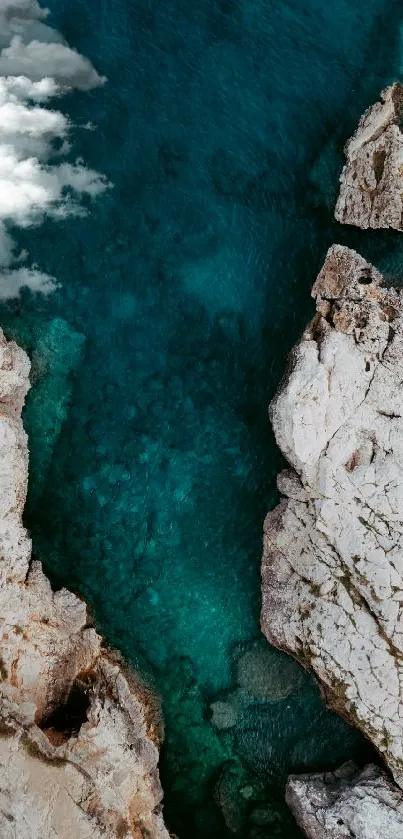 Aerial view of turquoise waters and coastal rocks.