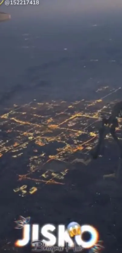 Aerial view of city lights glowing at night, seen from an airplane window.