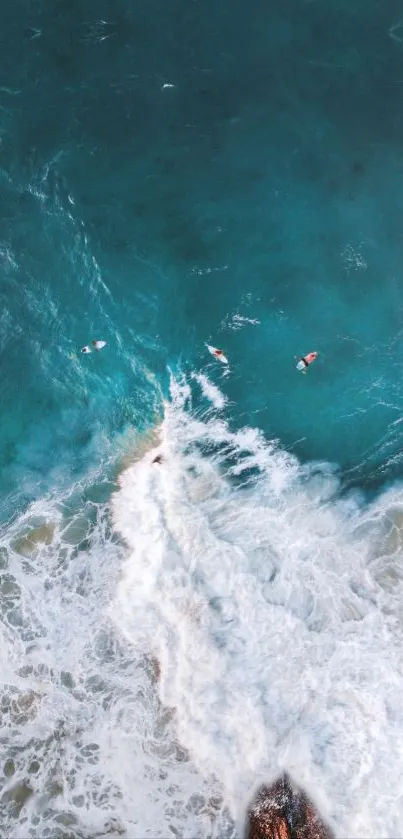 Aerial view of surfers in turquoise ocean waves.