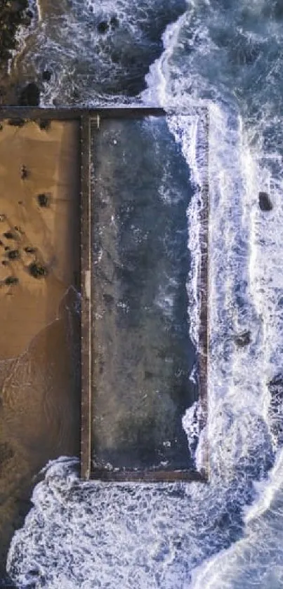 Aerial view of waves meeting a sandy shore.