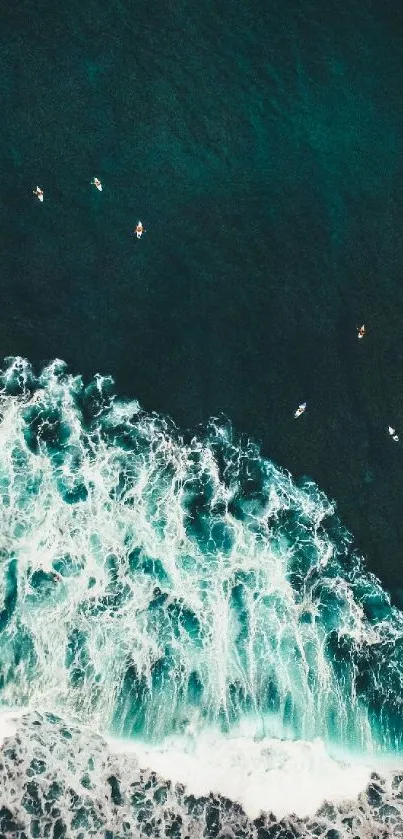 Aerial view of ocean waves crashing, with a deep teal sea background.