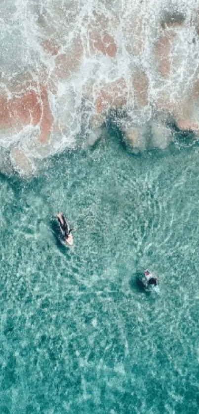 Aerial view of turquoise ocean with waves and swimmers.