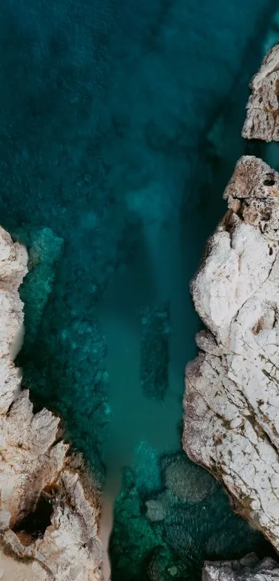 Aerial view of a rocky coastline with turquoise waters and rugged textures.