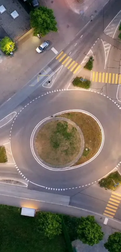 Aerial view of a roundabout at dusk with distinct urban design.