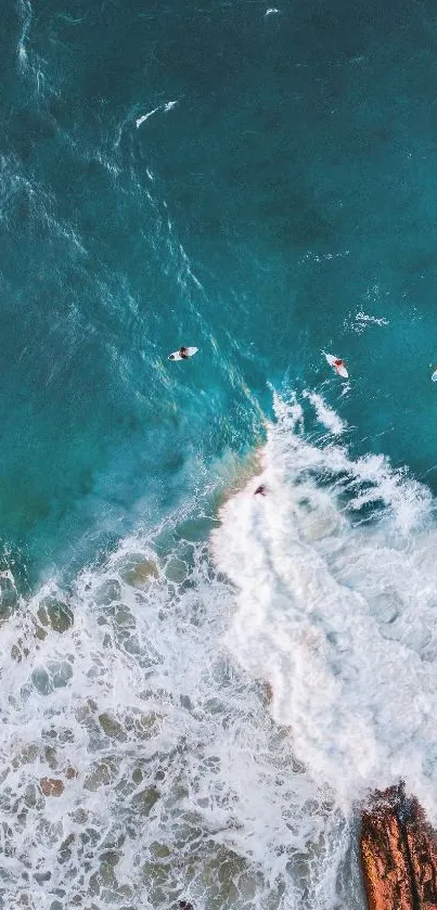 Turquoise ocean waves with surfers from above.