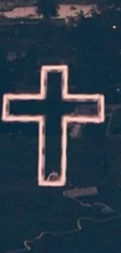 Aerial view of a neon-lit cross in the night.