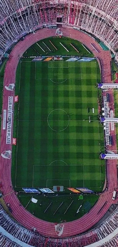 Aerial view of vibrant football stadium with green field and crowd.