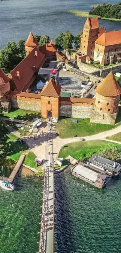 Aerial view of Trakai Castle with surrounding water and greenery.