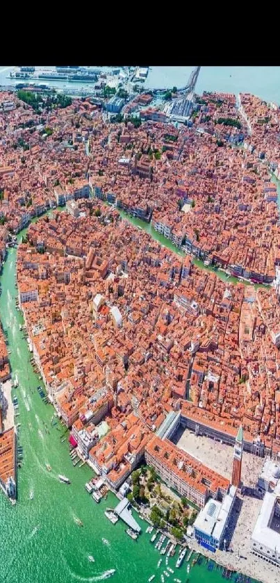 Aerial view of Venice cityscape with winding canals and historic buildings.