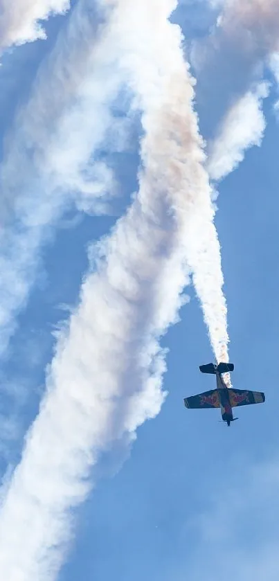 Aerobatic planes creating smoke trails against a blue sky backdrop.