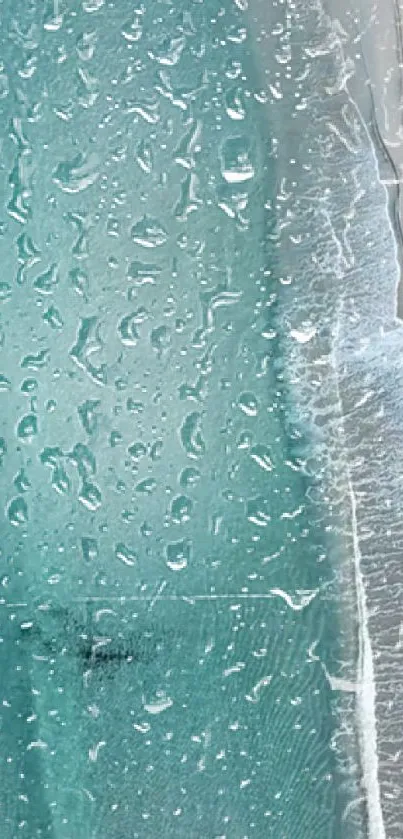 Aesthetic water droplets on a teal glass surface.