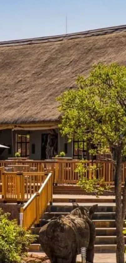 Rural African lodge with thatched roof and lush surrounding greenery.