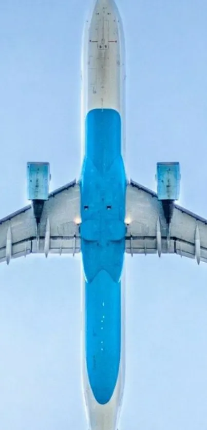 Aerial view of a blue airplane soaring in the sky.