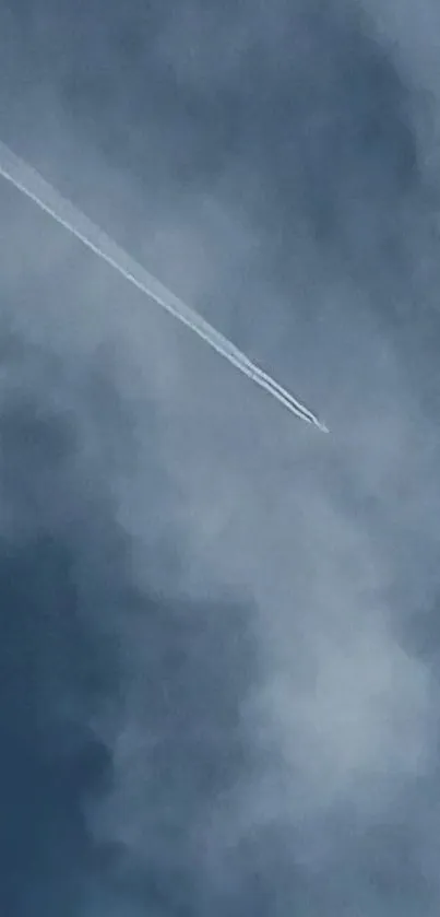 Airplane leaving a contrail across a cloudy blue sky.