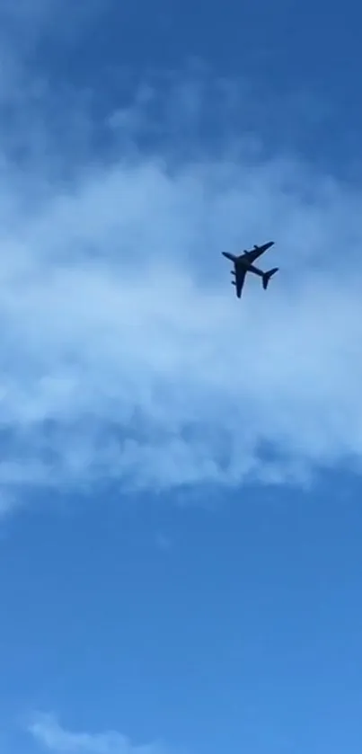 Jet flying in a sky with clouds and a serene blue background.