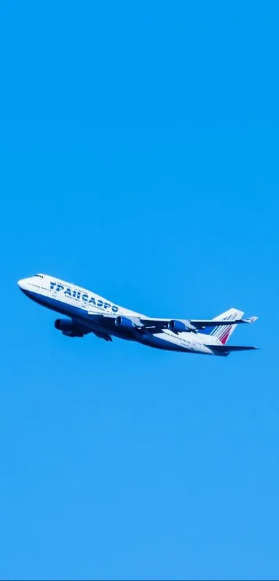 Airplane flying against a clear blue sky in a scenic view.