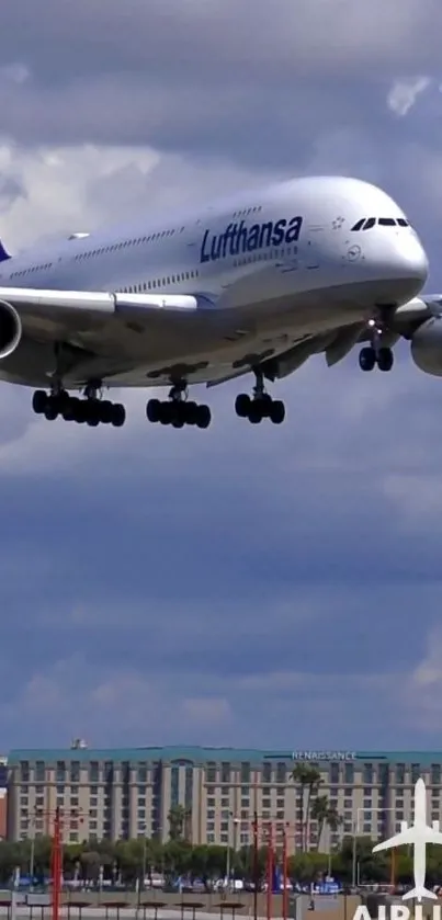 Airplane flying over city skyline under cloudy sky