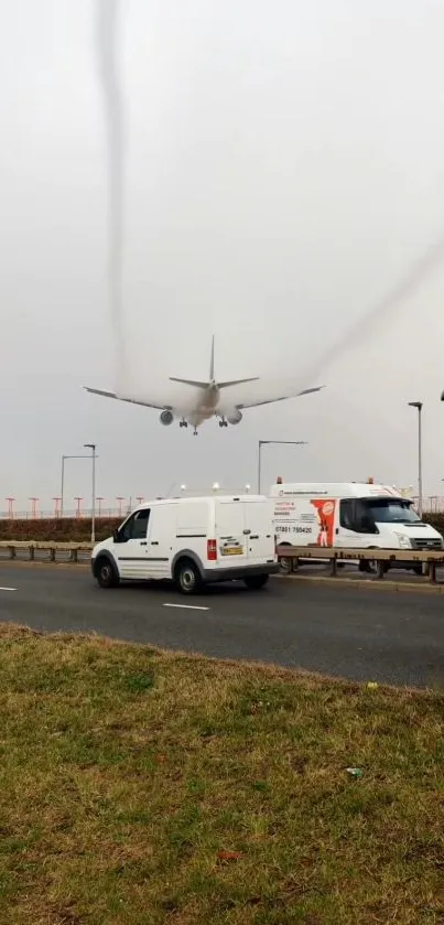 Airplane descends over roadside with vehicles.