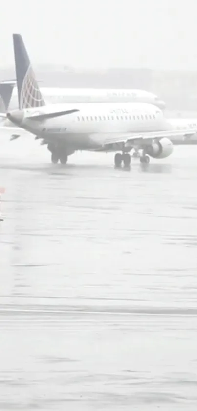 Airplane parked on a wet, rainy runway with cloudy skies.