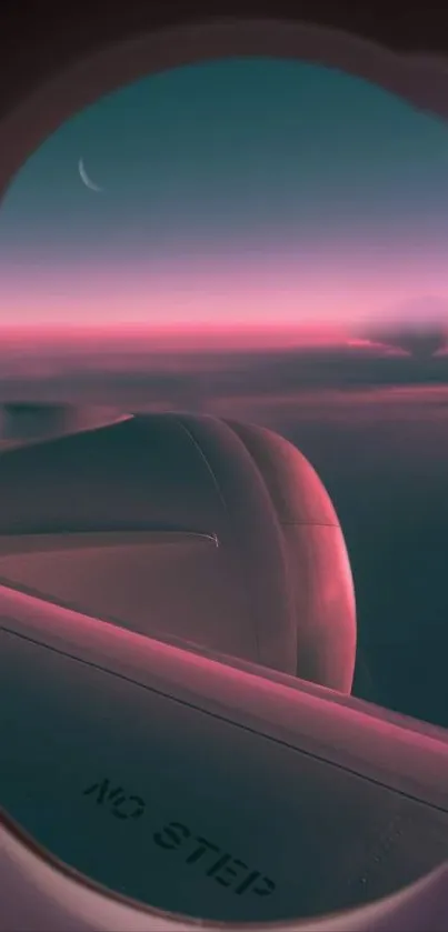 Airplane window view of a stunning pink sunset over the clouds.