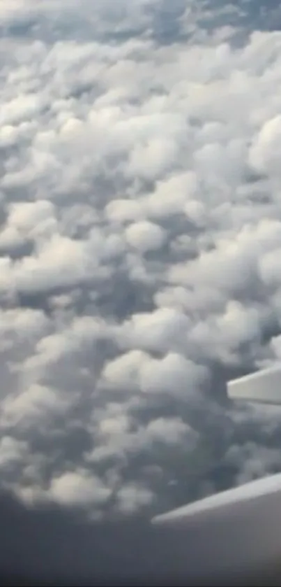 View of clouds from an airplane window, capturing the serene beauty of the sky.