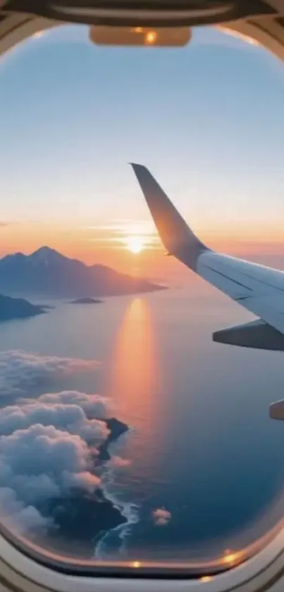 Sunset through airplane window over mountains and sea.