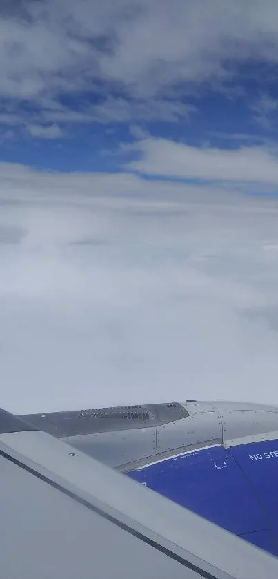 Airplane window view with blue sky and clouds.