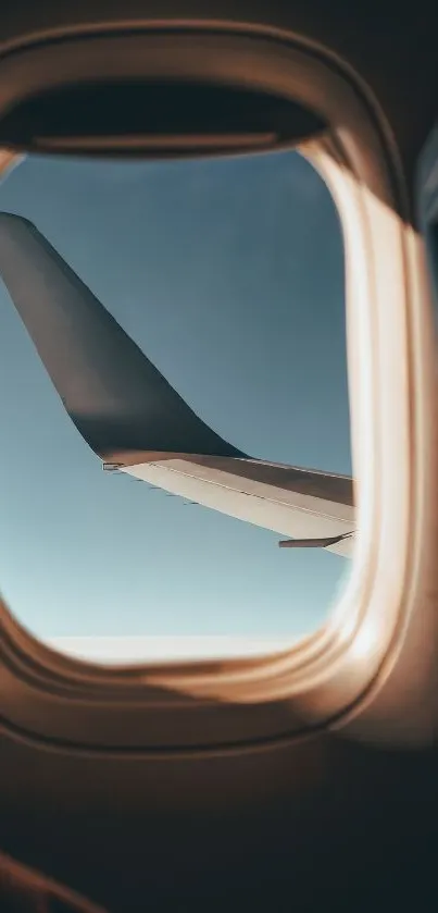 View from airplane window with wing against clear sky background.