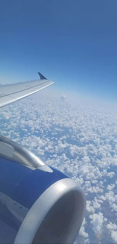 Airplane wing soaring above white fluffy clouds in a blue sky.