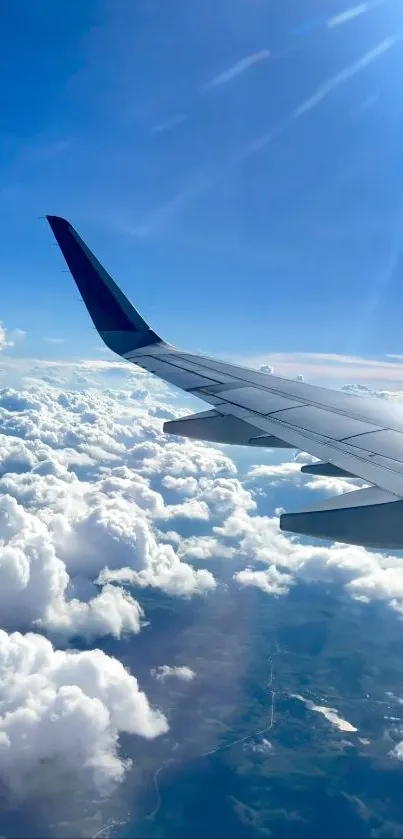 Airplane wing over clouds and blue sky wallpaper.