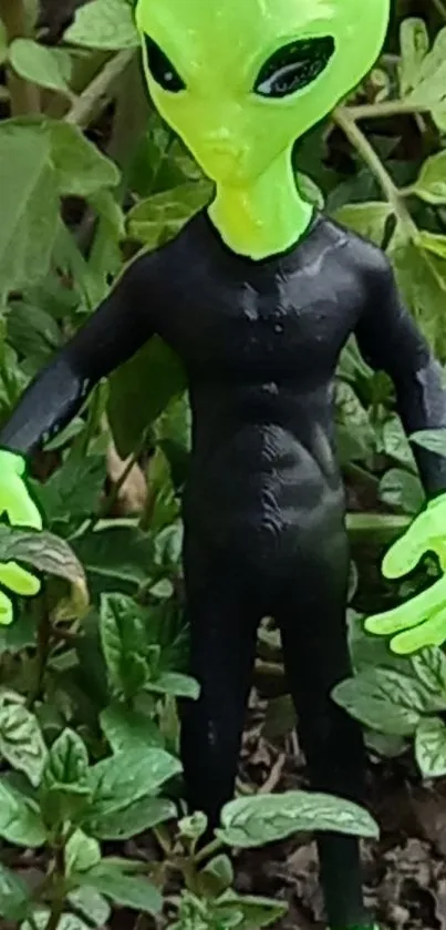 Green alien figure standing in lush greenery.