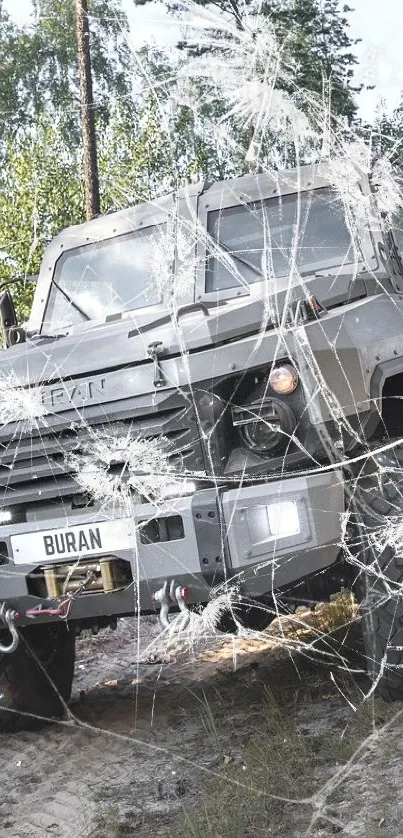 Armored vehicle driving through a forest trail.