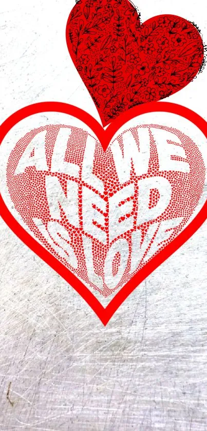 Red heart with 'All We Need Is Love' text on textured background.