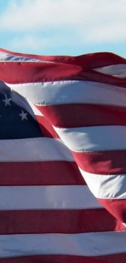 American flag waving on a clear day sky background.